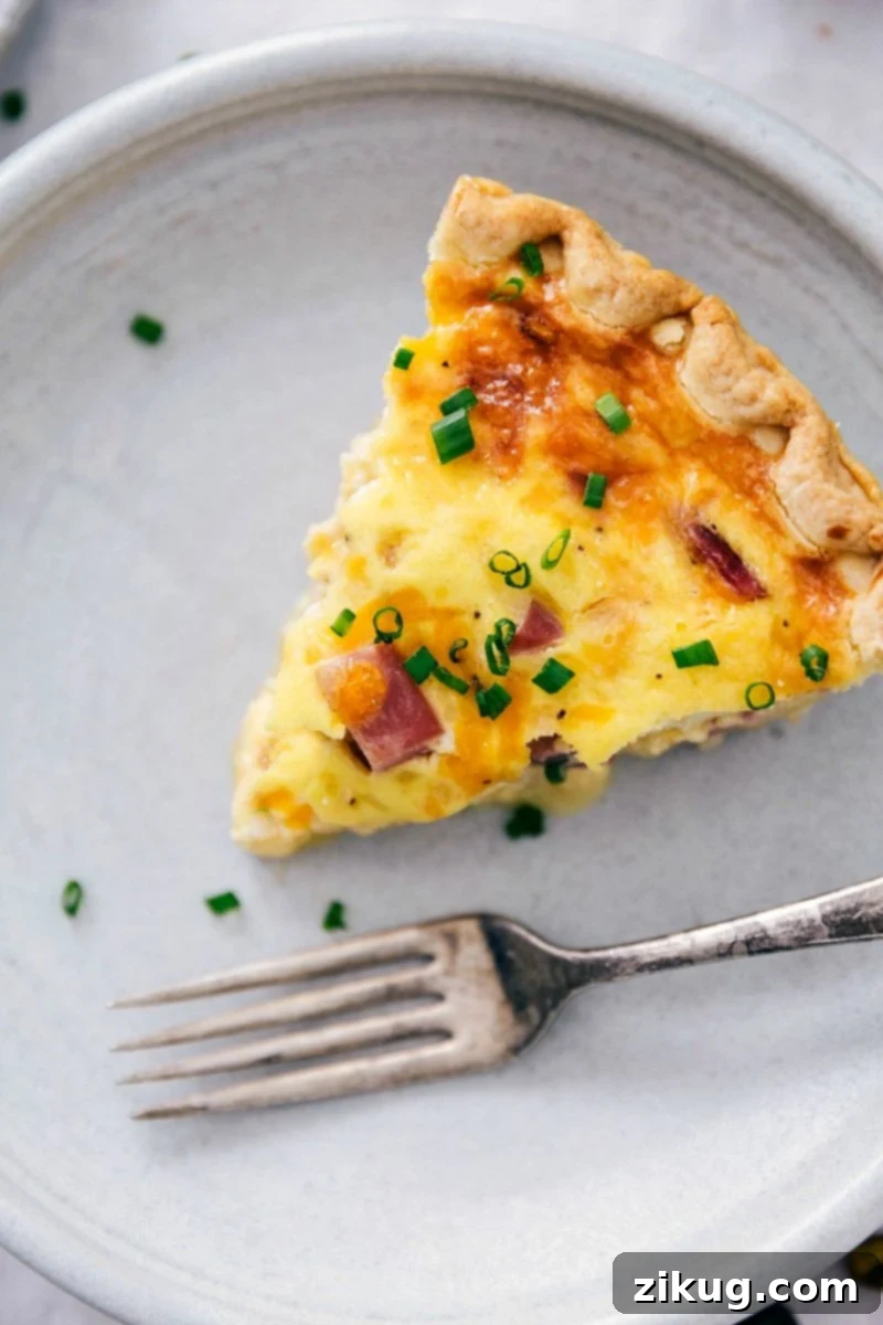 Serving a Slice of Homemade Ham and Cheese Quiche Slice of scrumptious ham and cheese quiche.