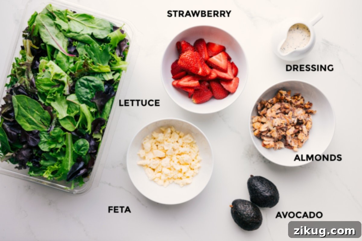Ingredients In Strawberry Poppyseed Salad Recipe All the fresh ingredients for the Strawberry Poppyseed Salad meticulously prepped and arranged on a wooden board, including a bowl of mixed greens, bright red sliced strawberries, diced creamy avocado, crumbled white feta cheese, and a jar of golden candied almonds ready for assembly.