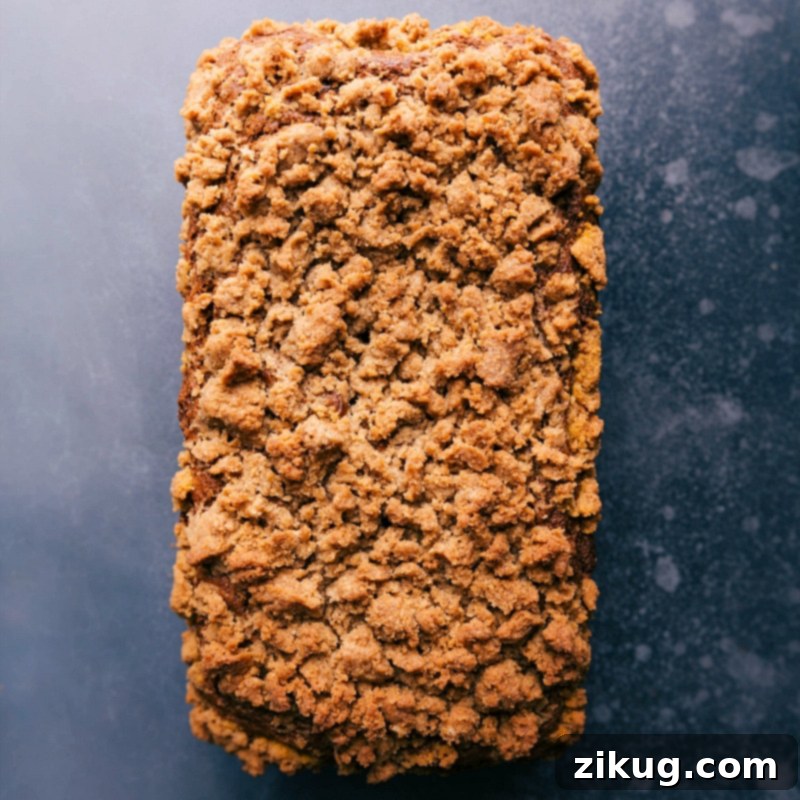 Freshly baked pumpkin bread with golden streusel topping.