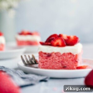 Beautifully frosted Strawberries and Cream Cake with sugared strawberries on top, ready to be served.