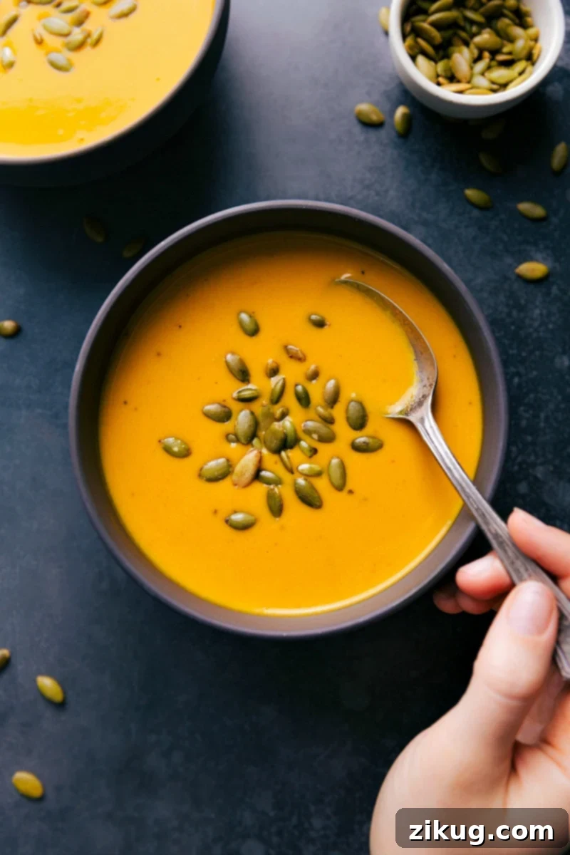 Healthy and Delicious Carrot Soup with Pepita Seeds Carrot Soup in a bowl garnished with pepita seeds, a healthy and delicious meal.