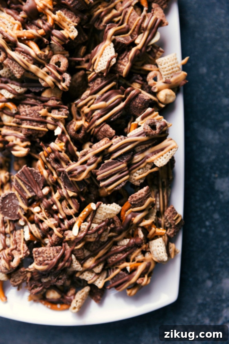 The Ultimate Sweet & Salty Delight - Chocolate-Peanut Butter Snack Mix A large bowl overflowing with homemade chocolate peanut butter snack mix, showcasing its rich textures and inviting colors. Perfect for sharing or a personal indulgence.