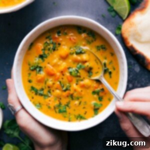 Creamy Sweet Potato Coconut Curry Soup 2 A rich and aromatic bowl of Sweet Potato Coconut Curry Soup, generously packed with tender sweet potatoes, hearty chickpeas, and fresh kale, perfect for a nourishing meal.