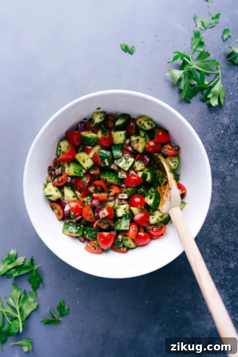 Fresh Israeli salad in a serving bowl with vibrant vegetables and herbs.
