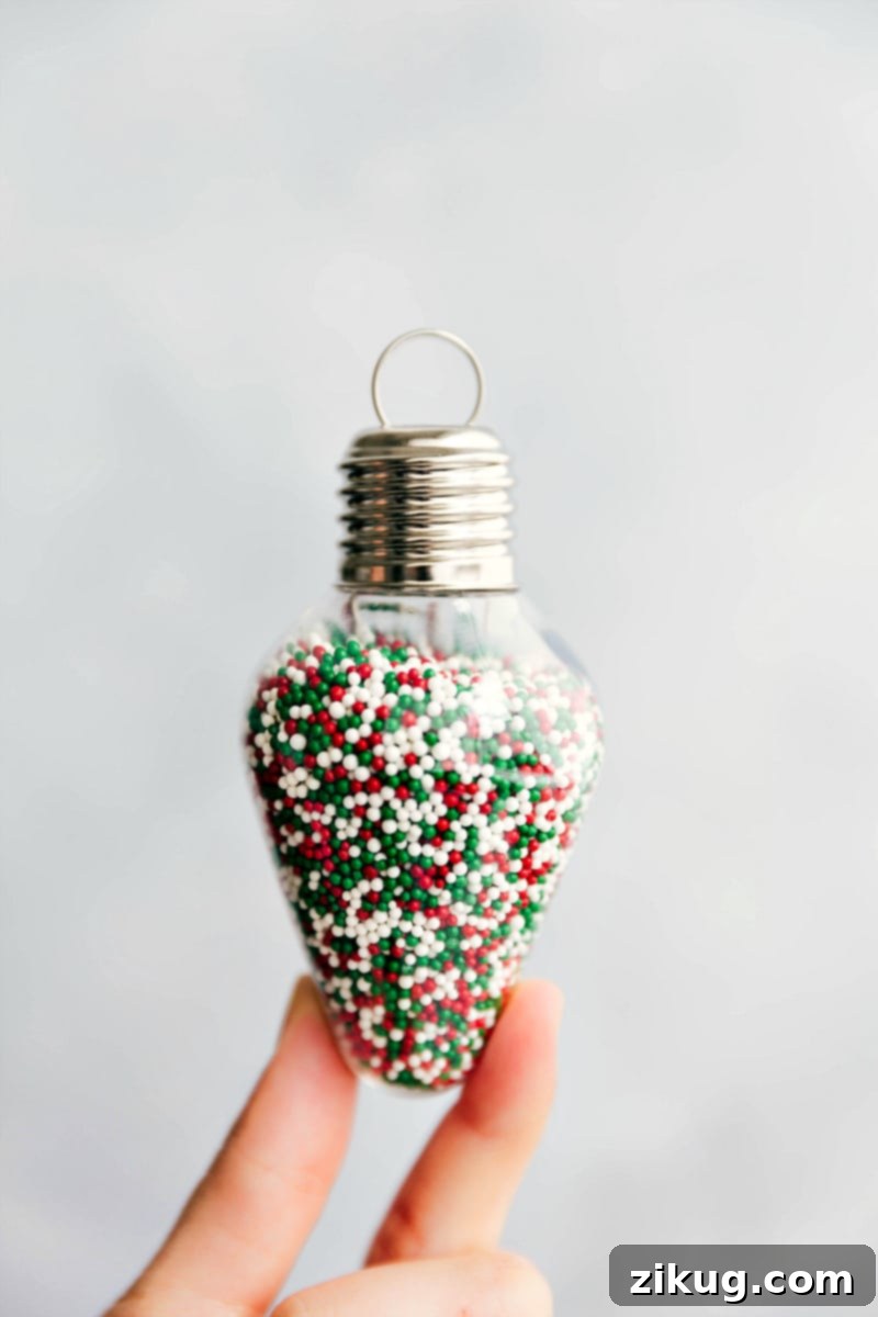 Image of sprinkles in an ornament-shaped jar, perfect for a DIY Christmas cookie kit