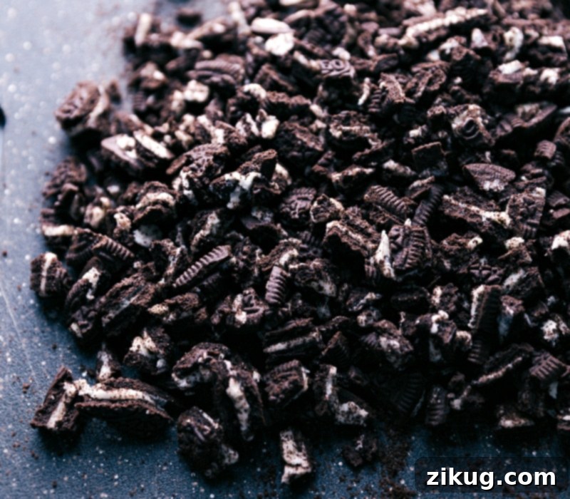 Decadent Oreo Chocolate Fudge 3 A pile of roughly chopped Oreo cookies, ready to be incorporated into the homemade fudge recipe.