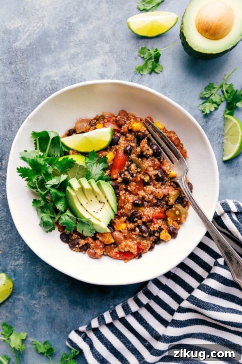Fajita-inspired flavors make up this delicious, nutritious Crockpot Quinoa. Throw everything (uncooked) into a slow cooker and forget about it as the appliance works its magic! (Vegetarian recipe.) Recipe via ChelseasMessyApron #dinner #quick #easy #simple #best #healthy #avocado #cilantro #crockpot #quinoa Fajita-inspired Crockpot Quinoa dish, ready to be served
