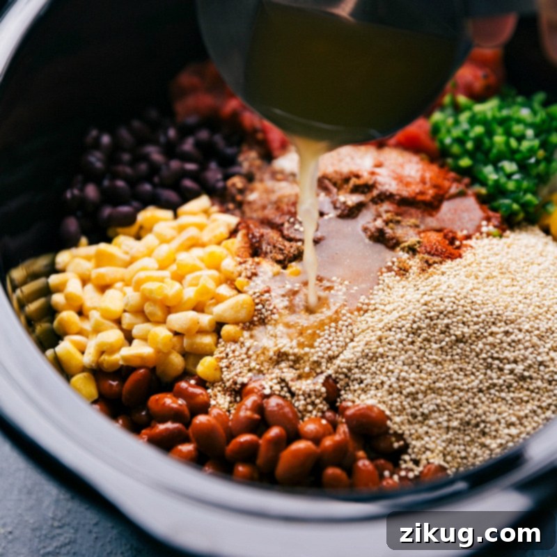 The best-ever Crockpot Quinoa dish. Throw everything (uncooked) into a slow cooker and forget about it as the appliance works its magic! (Vegetarian recipe.) Recipe via ChelseasMessyApron #dinner #quick #easy #simple #best #healthy #avocado #cilantro #crockpot #quinoa Adding vegetable stock to Crockpot Quinoa during preparation.