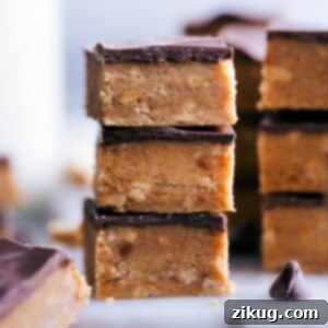 A perfectly stacked square of Peanut Butter Crunch Candy, showcasing its crispy layers and rich chocolate topping.
