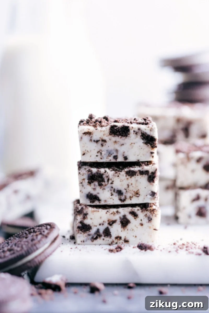 Irresistible No-Bake Oreo Fudge A stack of delightful Oreo Fudge pieces, showcasing the creamy texture and crushed Oreo chunks.