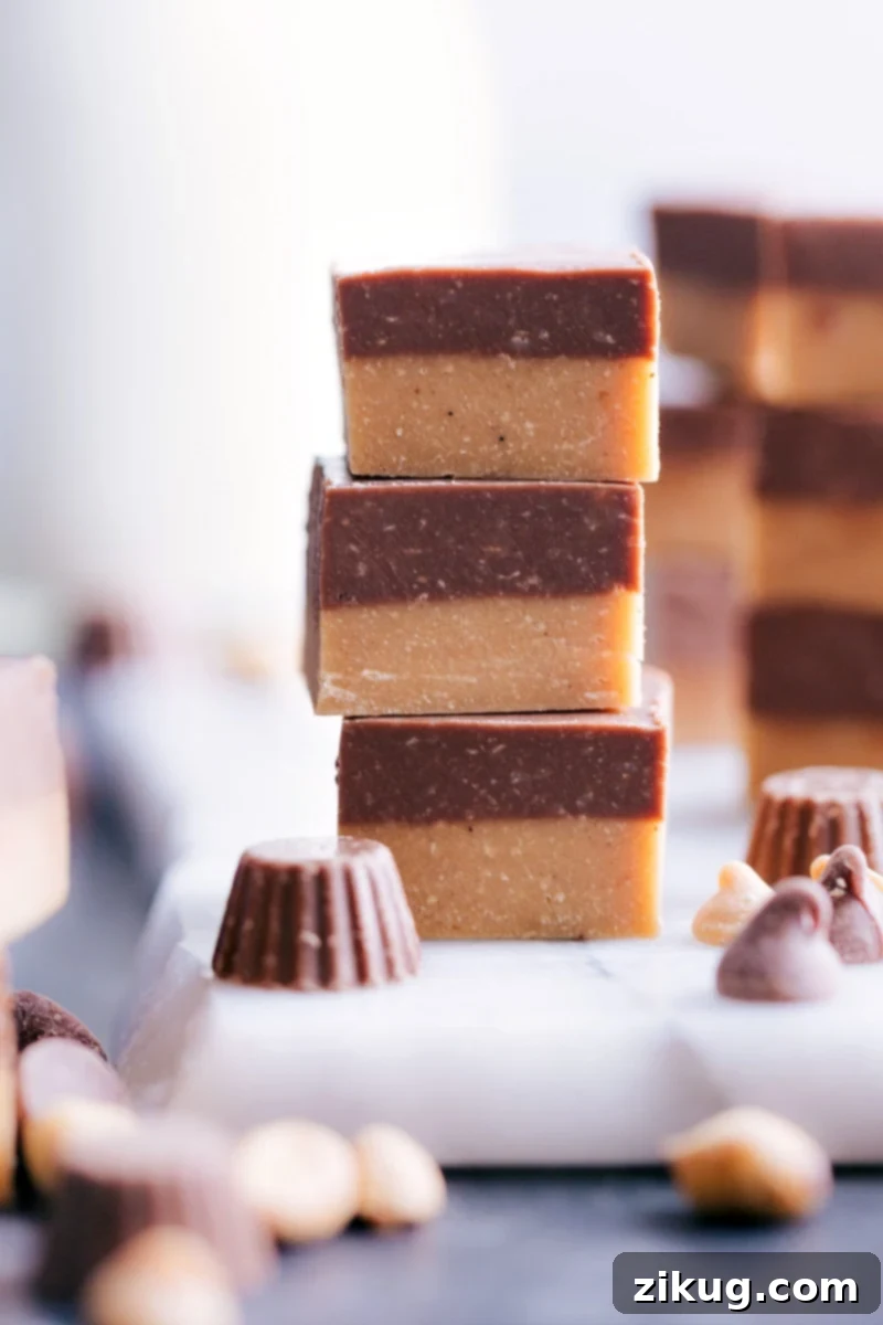 Homemade Reese's Fudge: Easy stovetop recipe with rich peanut butter and milk chocolate layers, ready in under 30 minutes. Three perfectly cut pieces of layered Reese's Fudge, showcasing the distinct peanut butter and milk chocolate layers.