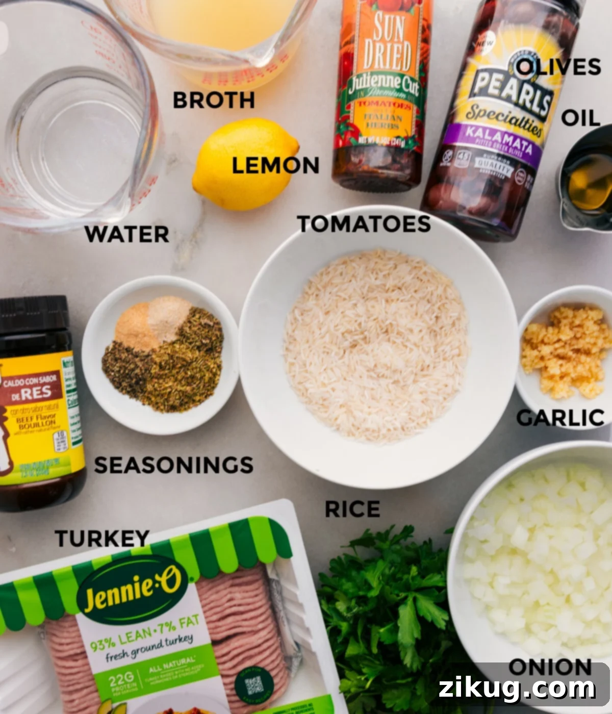 Key Ingredients for Greek Ground Turkey Prepared ingredients for Greek Ground Turkey Bowls, including rice, fresh vegetables, ground turkey, various seasonings, Kalamata olives, sun-dried tomatoes, olive oil, broth, water, and fresh lemons.