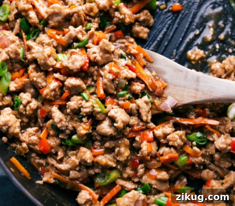 These nutritious bowls are packed with Close-up view of the Asian Ground Turkey, still in the pan, showcasing its rich color and texture.