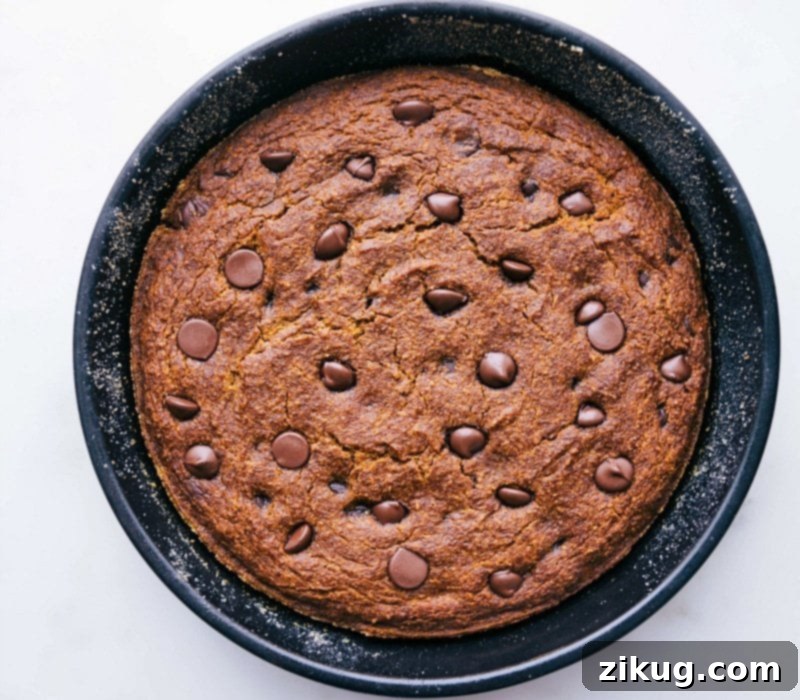 Delicious Gluten-Free Pumpkin Cake Fresh Out of the Oven A whole, freshly baked gluten-free pumpkin cake, golden brown and radiating a warm, inviting aroma, cooling on a wire rack.