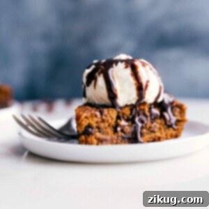 Perfectly Spiced Gluten-Free Pumpkin Cake 3 Gluten-free pumpkin cake on a plate, crowned with a scoop of ice cream, prepared for a delicious treat.
