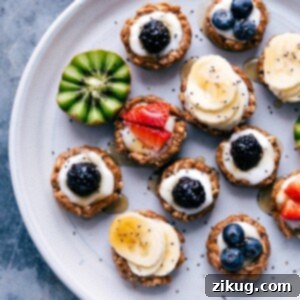 Wholesome Fruit Tart 2 Healthy fruit tarts beautifully displayed on a tray, adorned with a variety of fresh fruit toppings.