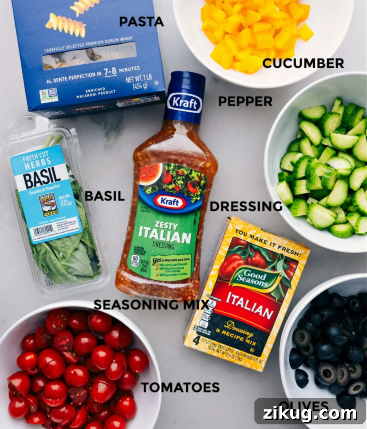 The Ultimate Easy Pasta Salad A beautifully arranged selection of fresh pasta salad ingredients: colorful rotini, bright bell peppers, cherry tomatoes, olives, and cucumbers, all prepped and ready for assembly on a rustic wooden board.
