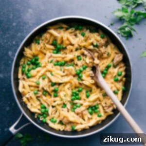 Ultimate Weeknight Tuna Pasta 2 Tuna pasta in a skillet with peas and cheese, creating a savory and hearty meal.
