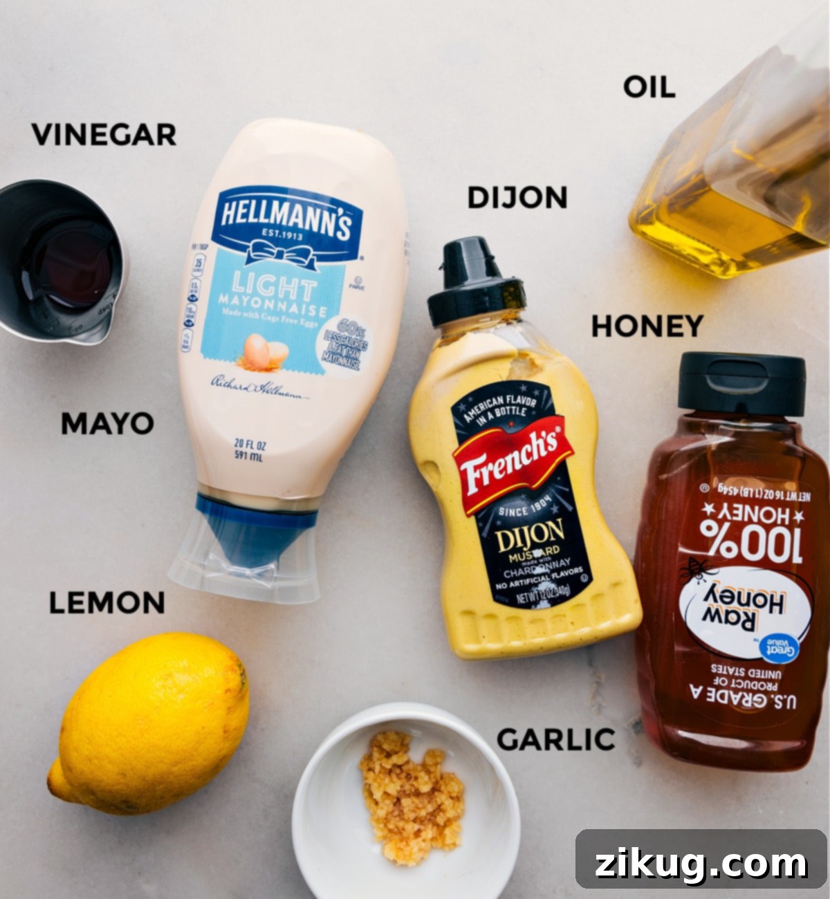 The Dressing In Tuna White Bean Salad Fresh ingredients like mayonnaise, red wine vinegar, Dijon mustard, olive oil, honey, lemon, and minced garlic, all prepped to create the flavorful dressing for the tuna white bean salad.