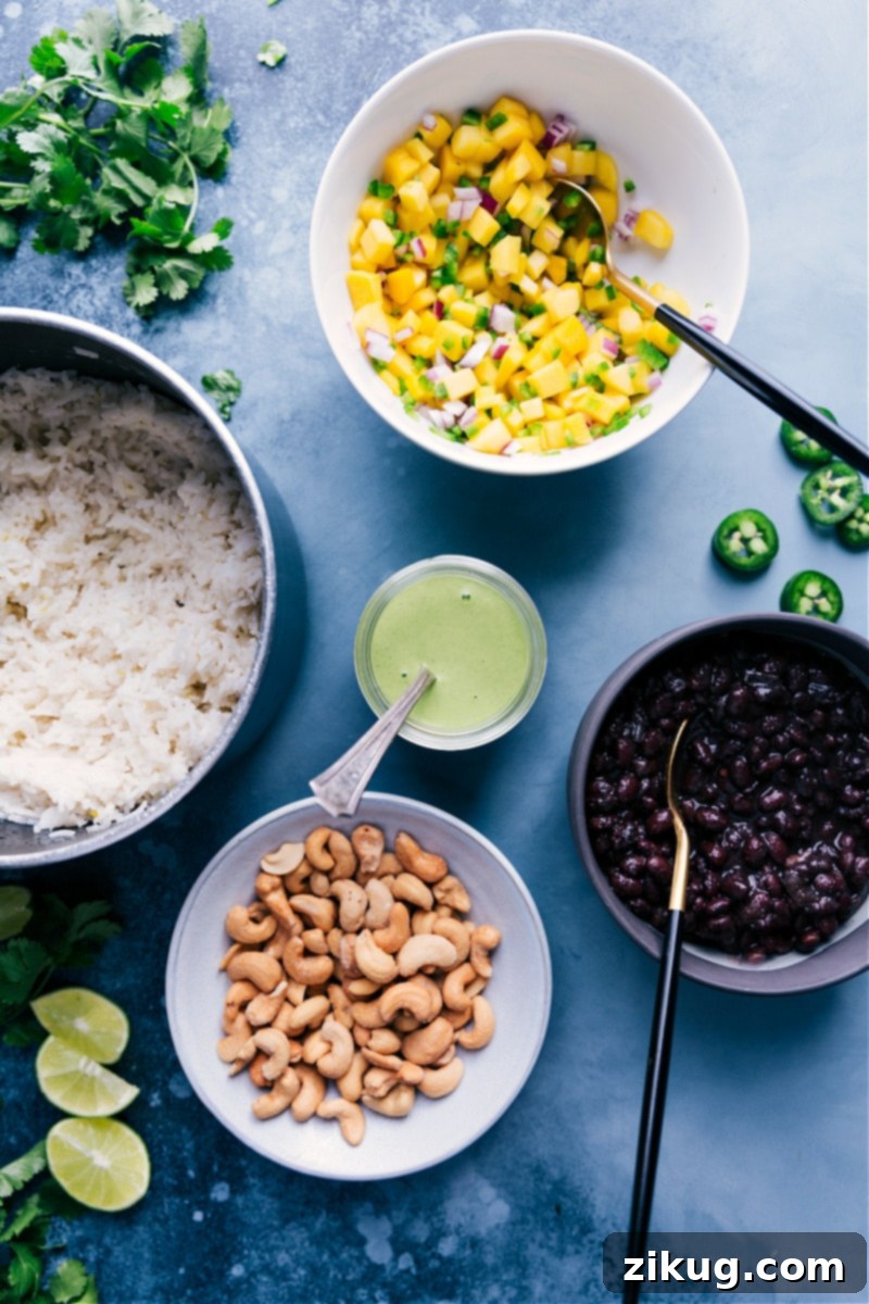 All the delicious components of Black Bean Bowls ready for assembly. Overhead view of all the prepared components for Black Bean Bowls arranged separately before assembly.