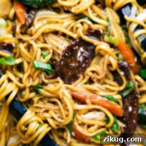 Classic Beef Chow Mein 4 Finished Beef Chow Mein with tongs holding the noodles.