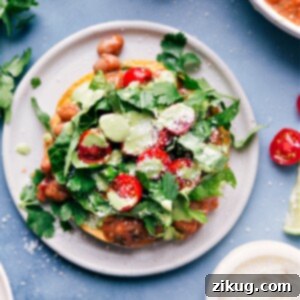 Crispy Bean Tostadas 3 A beautifully plated Bean Tostada with avocado, pinto beans, and fresh toppings.