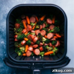 Honey Mustard Chicken Sausage and Veggies meal in a bowl, drizzled with sauce.