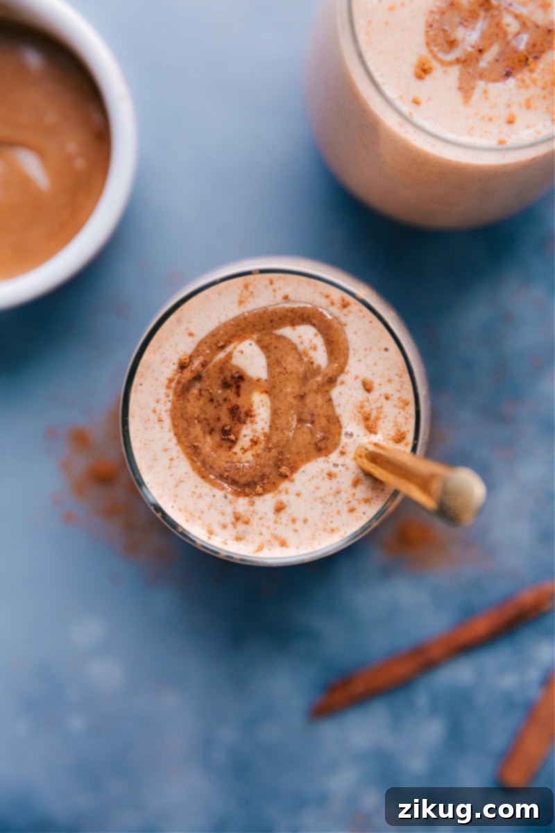 Experience the magic of a healthy Cauliflower Smoothie that tastes like a cinnamon roll – packed with hidden veggies and flavor! Overhead image of Cauliflower Smoothies garnished with cinnamon, in two glasses.