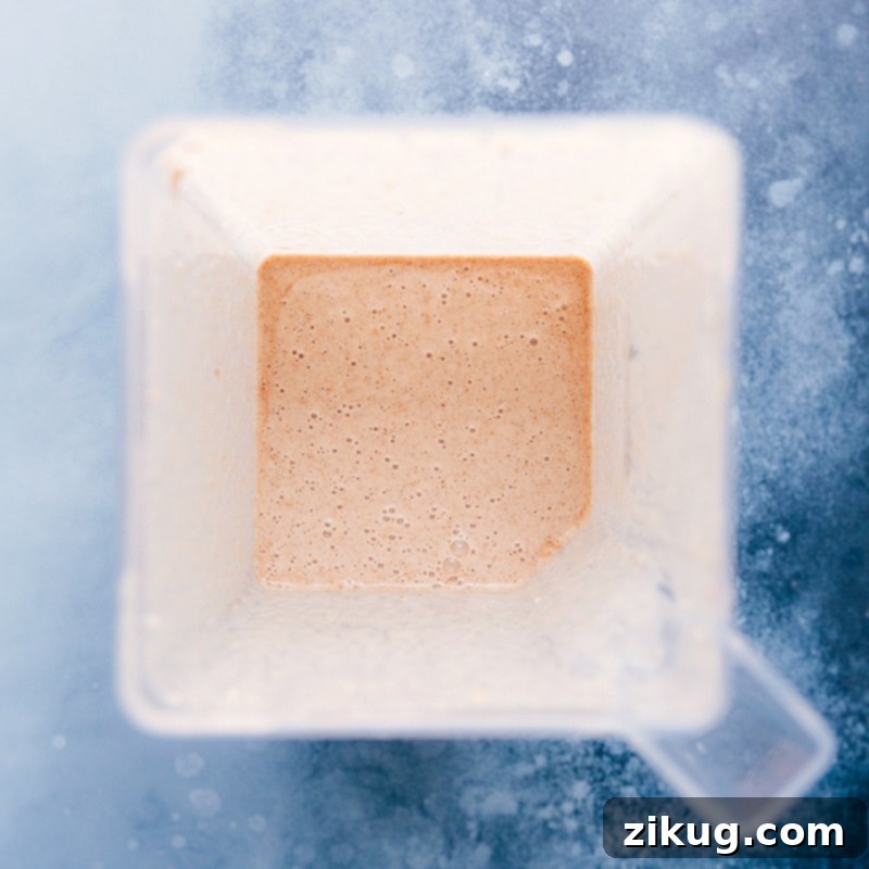 The smooth and creamy texture of the Cauliflower Smoothie, blending perfectly. Image of the Cauliflower Smoothie in the blender, showing its thick texture.
