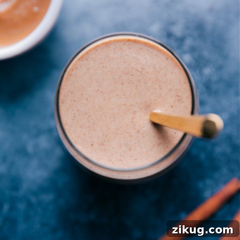 The delectable Cauliflower Smoothie, perfectly blended and ready for you to savor. Image of the smoothie in a cup with a spoon in it, ready to be served and enjoyed.