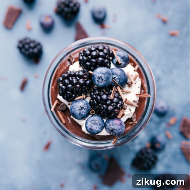 Chocolate Chia Seed Pudding with whipped cream and fresh berries on top