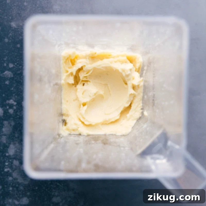 Creamy pineapple mixture in a blender, perfectly blended.