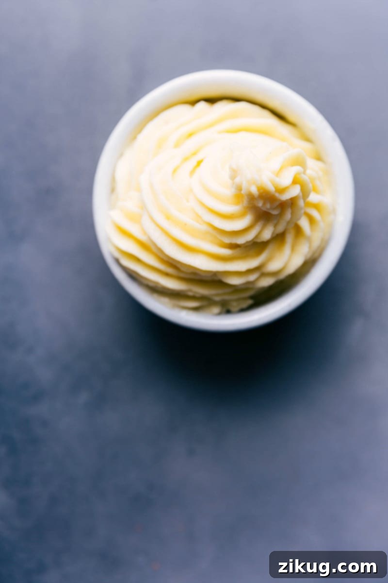 Bowl of homemade dole whip, fluffy and sweet, tempting the taste buds.