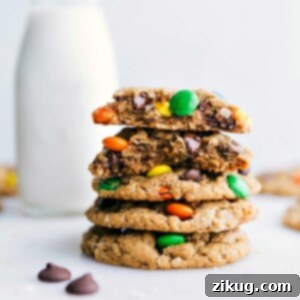Healthy Monster Cookies stacked on top of each other with one broken in half showing off the middle, highlighting their delicious gluten-free interior.