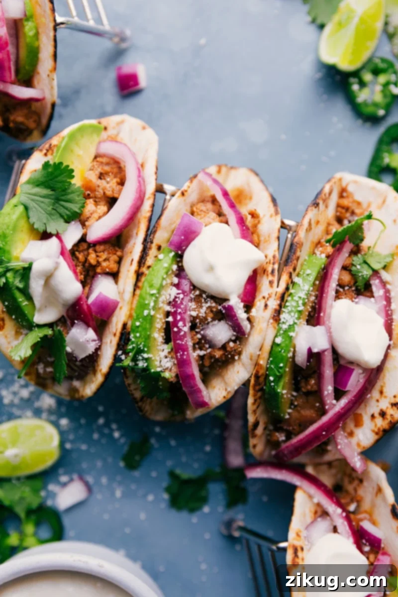 Irresistible Ground Pork Tacos – simple to make, big on flavor, and perfect for dinner! Close-up of three delicious ground pork tacos drizzled with lime crema