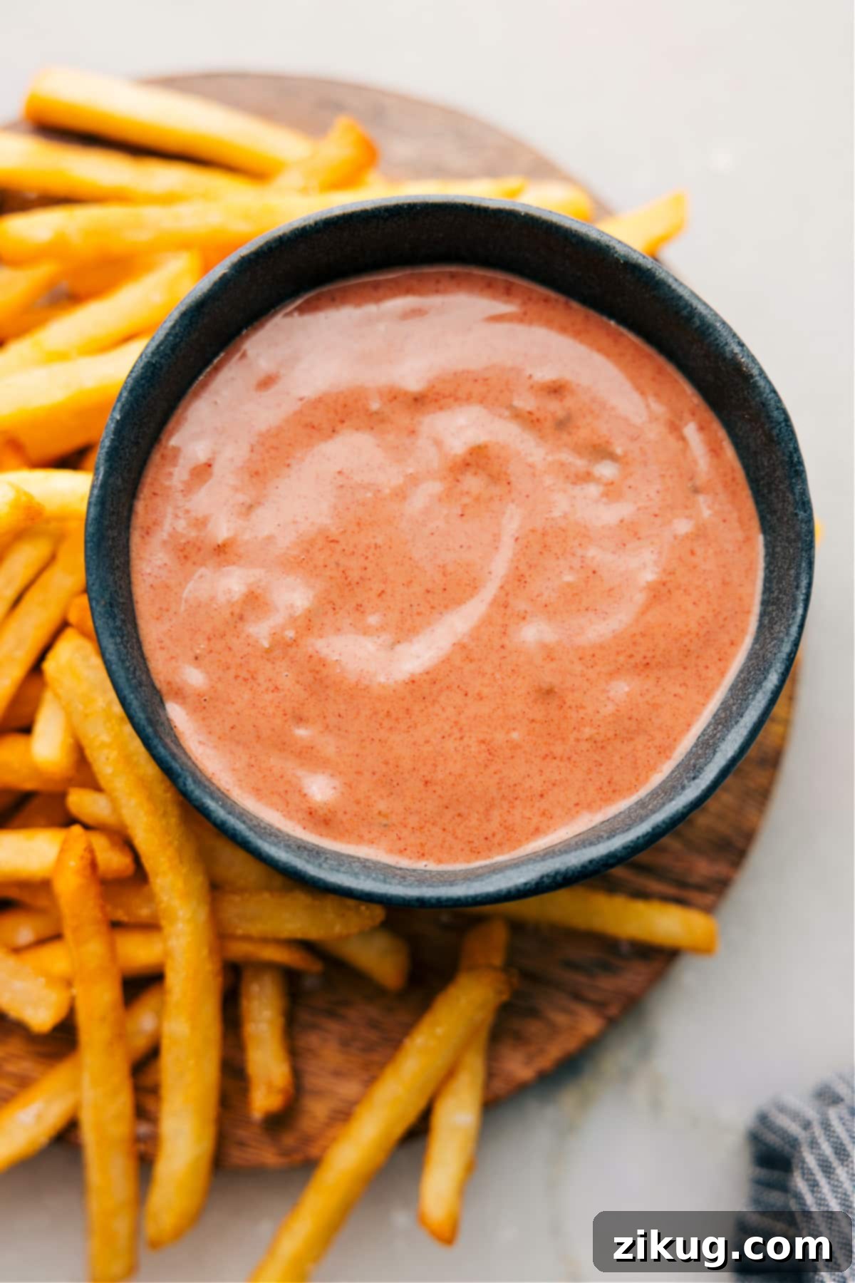 A vibrant bowl of the best homemade fry sauce, smooth and creamy, perfectly paired with a mound of golden, crispy french fries, ready for dipping.