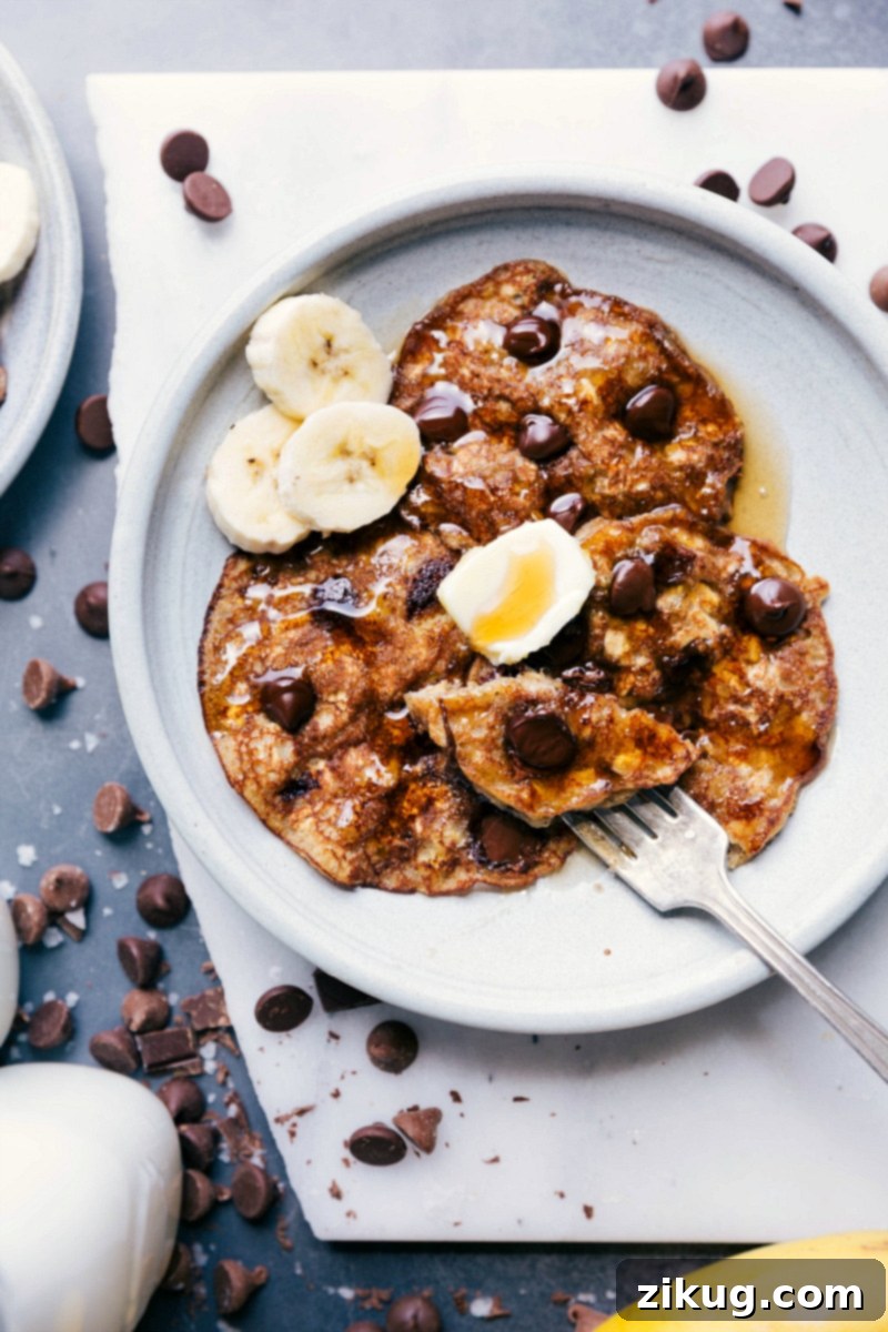 Warm and Flavorful Gluten-Free Banana Pancakes Topped with Butter and Fresh Bananas Warm and inviting gluten-free banana pancakes beautifully arranged, topped with a pat of melting butter and fresh banana slices, hinting at a delightful breakfast experience.