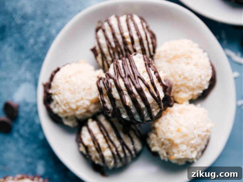 Simple Coconut Macaroons are made with minimal ingredients thanks to the Freshly baked Coconut Macaroons arranged beautifully, some dipped in chocolate.