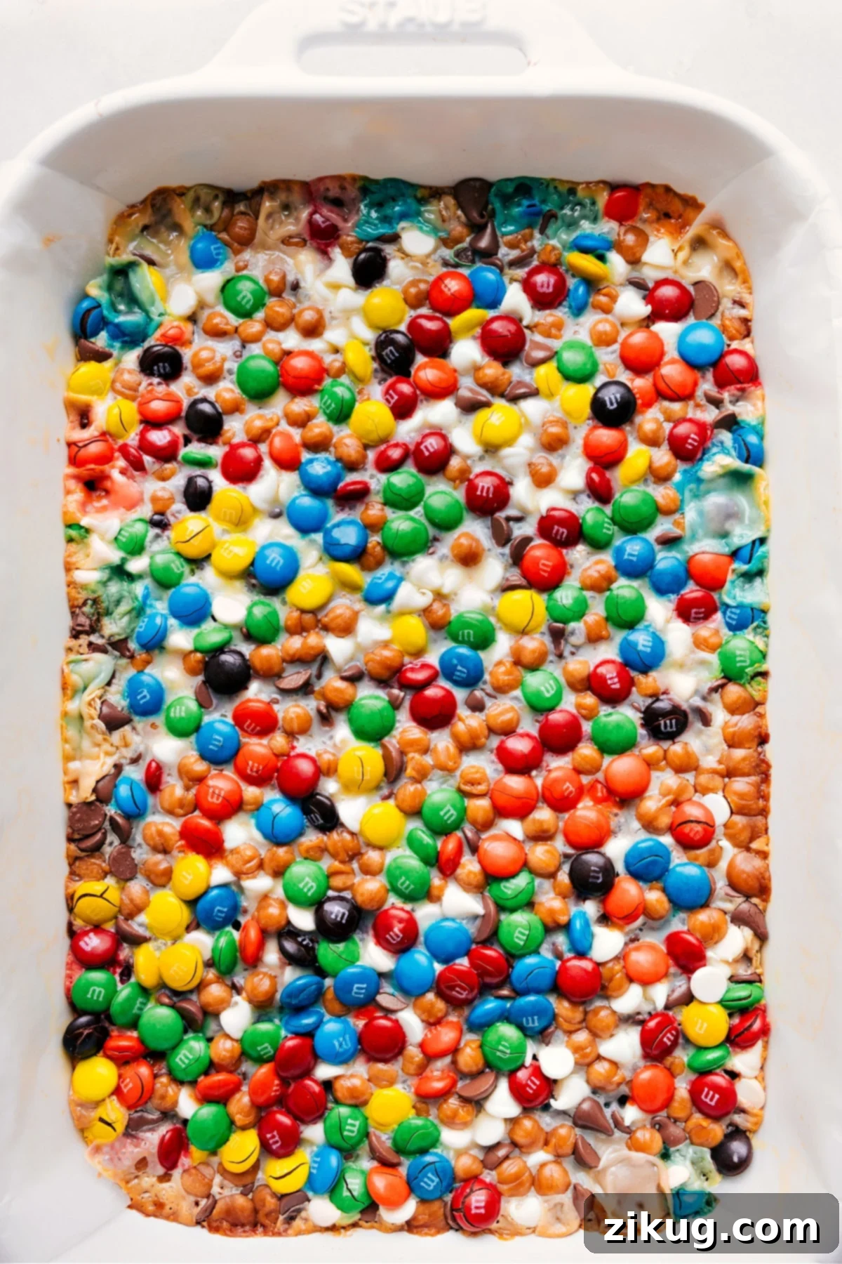 Freshly baked Magic Cookie Bars, golden brown and glistening, cooling on a wire rack, ready to be enjoyed.