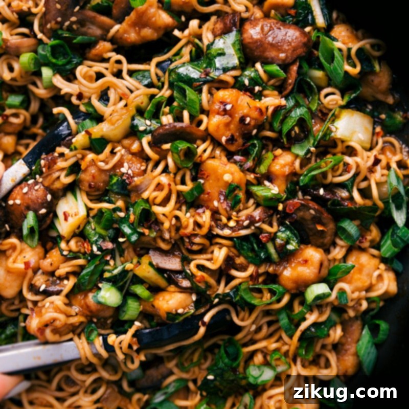 Close-up overhead view of General Tso Ramen, showcasing the noodles, chicken, bok choy, and sauce in a bowl.