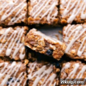 A perfectly portioned square of blueberry oatmeal bar, topped with a vanilla glaze, signifying the finished product.