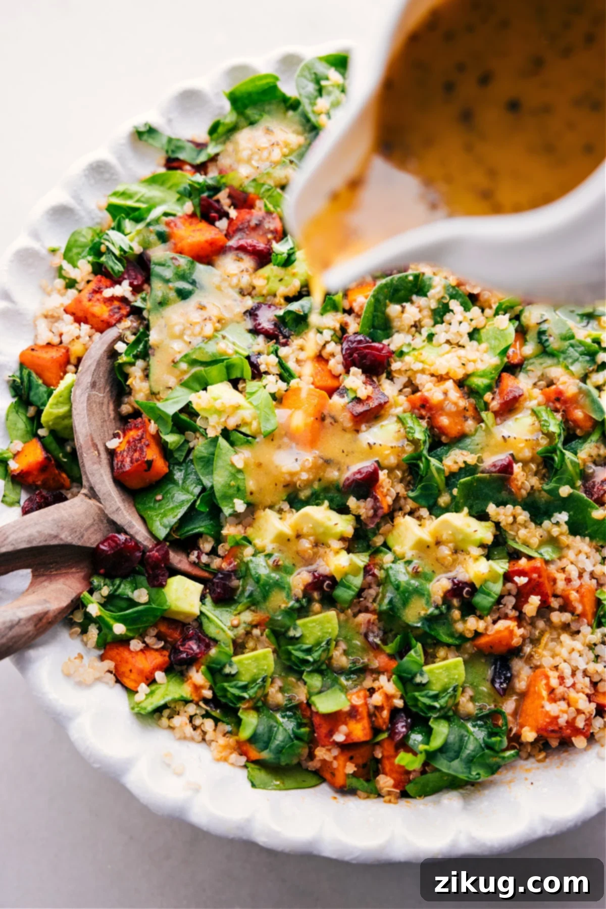 Serving Your Perfect Sweet Potato Quinoa Salad The perfect final touch: a generous and artistic drizzle of the vibrant tangy lemon dressing gracefully poured over a beautifully assembled bowl of Sweet Potato Quinoa Salad, enhancing its visual appeal and preparing it for a delightful culinary experience.