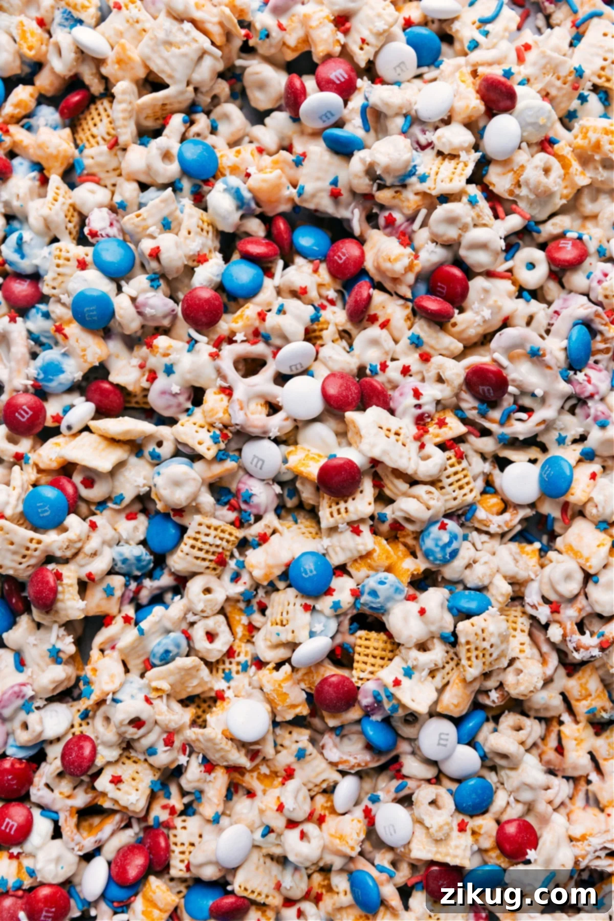 Delicious 4th of July Snack Mix for Festive Parties 4th of July Snack Mix on a tray ready to be enjoyed, showcasing red, white, and blue colors.