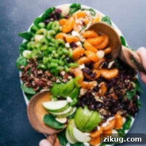 Autumn Crunch Pasta Salad in a bowl with ingredients scattered around