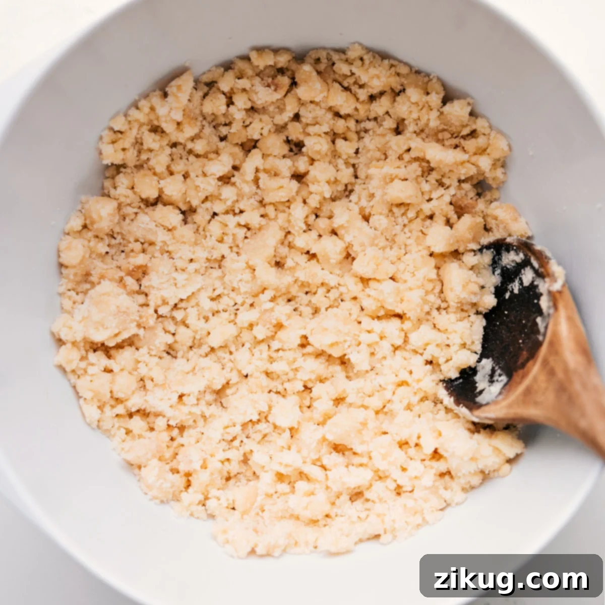 Crafting the Best Crumble Topping for Blueberry Cobbler A bowl filled with the irresistibly golden and crumbly topping for the Blueberry Cobbler Recipe, showcasing its perfect texture.