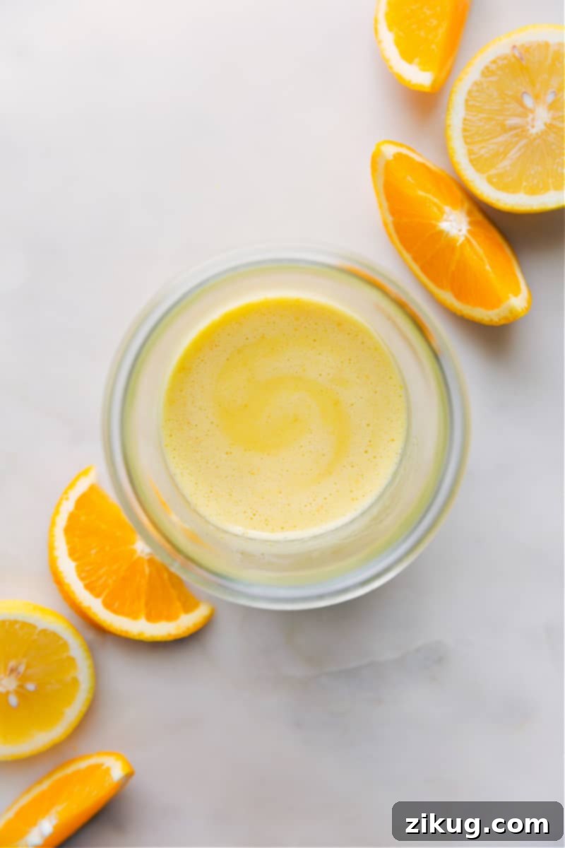 Homemade Citrus Vinaigrette: Sweet, Tangy, and Unforgettable! Overhead image of the Citrus Vinaigrette in a glass jar, highlighting its vibrant color and fresh ingredients, ready to be drizzled.