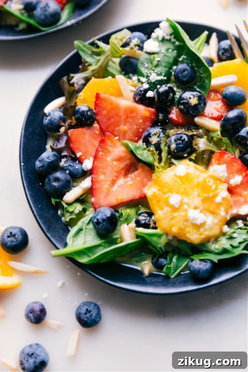 Enjoying a fresh salad dressed with our signature Citrus Vinaigrette. Close-up image of a vibrant green salad, glistening with homemade Citrus Vinaigrette, showcasing its freshness and appealing texture.