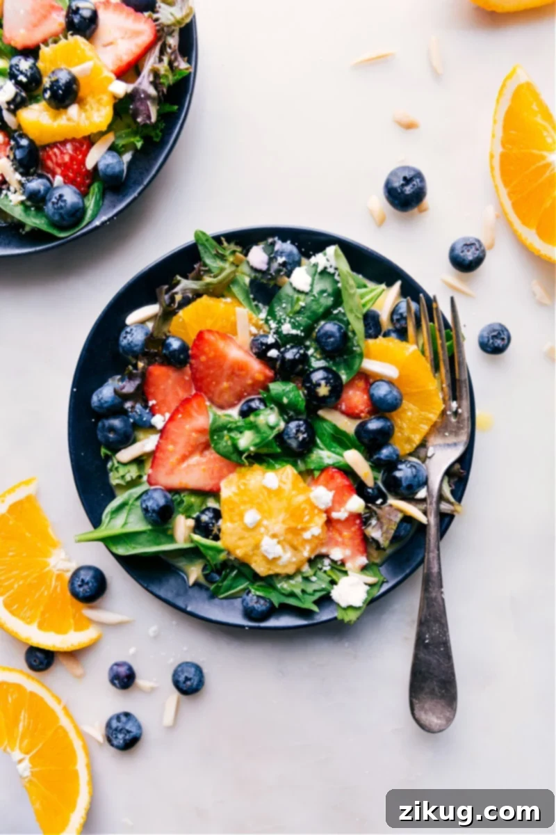 The ultimate homemade Citrus Vinaigrette makes every salad a masterpiece! Overhead image of a beautifully arranged, fully dressed salad, showcasing a delightful combination of fresh greens and colorful toppings enhanced by the citrus vinaigrette, making it an inviting meal.