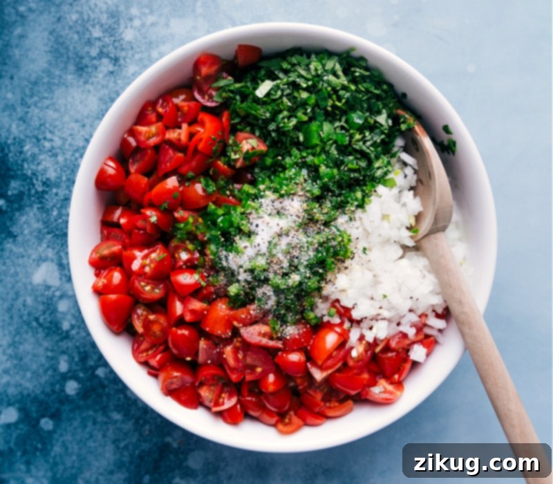 Seasoning classic Pico de Gallo with salt and pepper to enhance the fresh flavors before serving. Process shot of Pico de Gallo being seasoned with salt and pepper