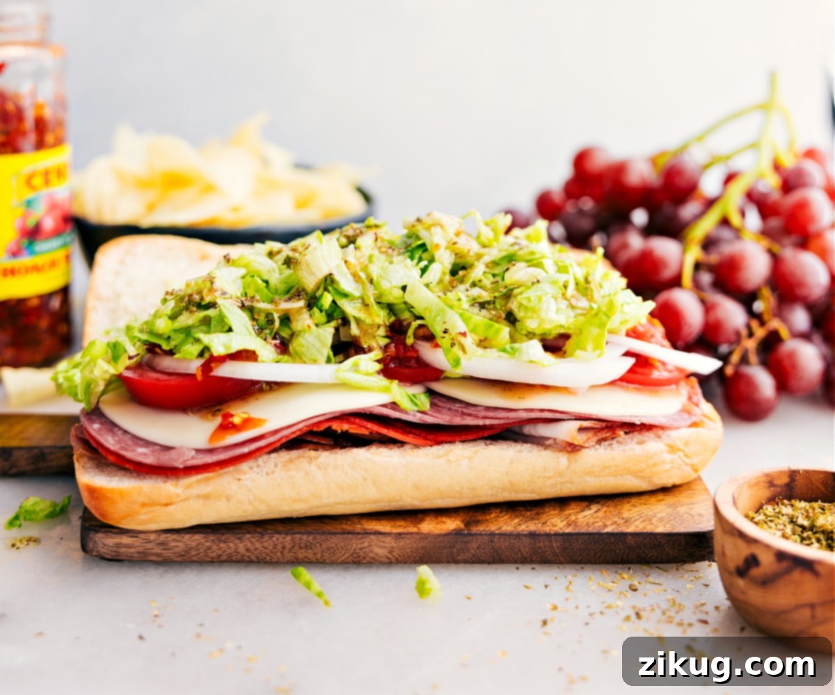 Assembling The Italian Hoagie Sandwich A hand carefully layering premium deli meats, provolone cheese, and fresh vegetables onto a crusty hoagie roll, highlighting the meticulous assembly process.